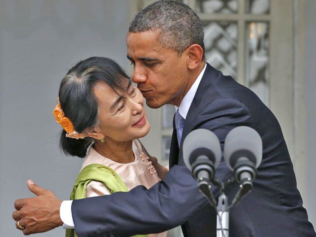US President Barack Obama kisses and hugs Myanmar opposition leader Aung San Suu Kyi