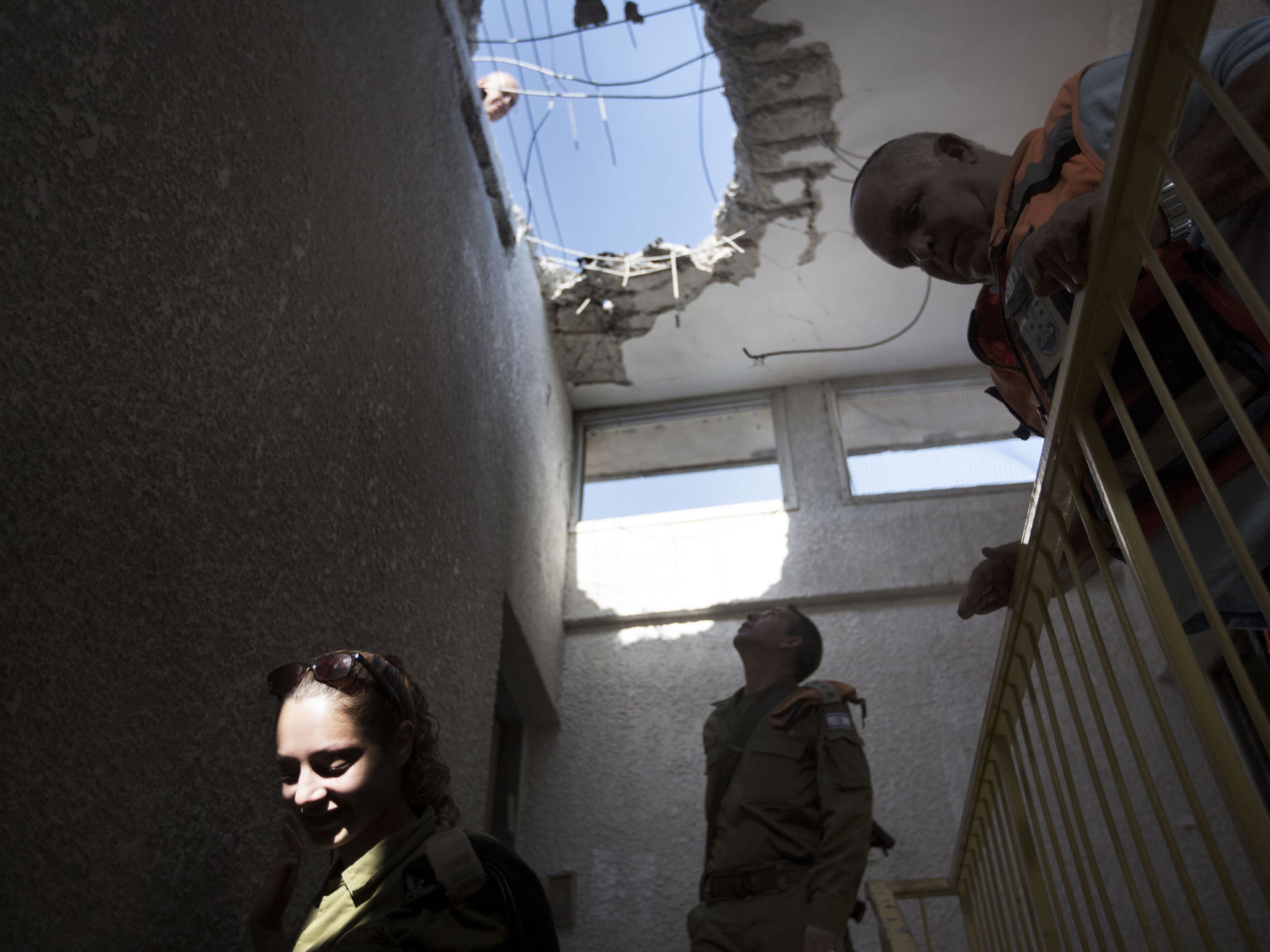 Israelis inspect damage caused by a Palestinian missile