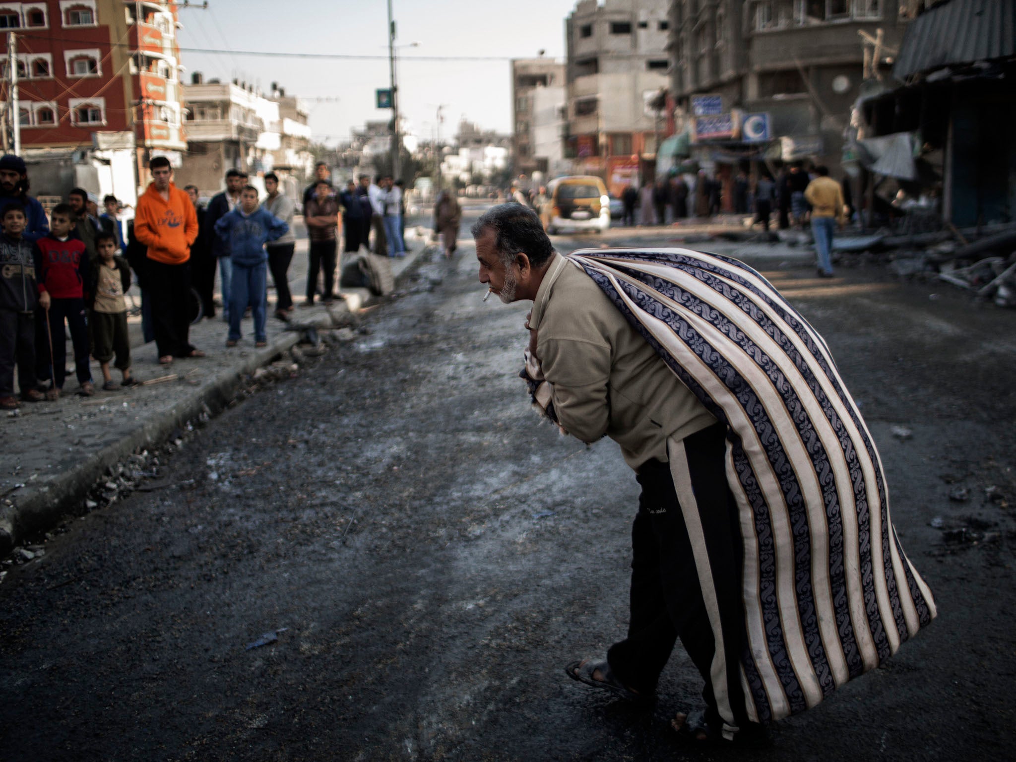 A Palestinian rescues possessions from a destroyed home