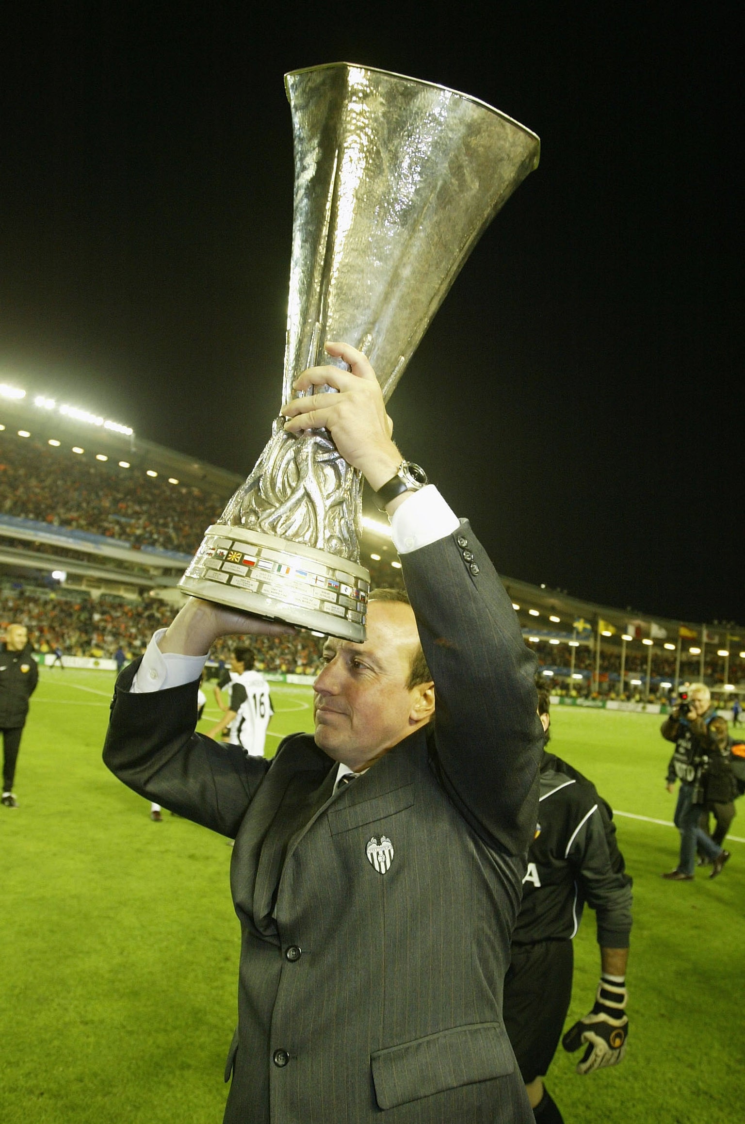 Rafael Benitez celebrates with the Uefa Cup after Valencia beat Marseille