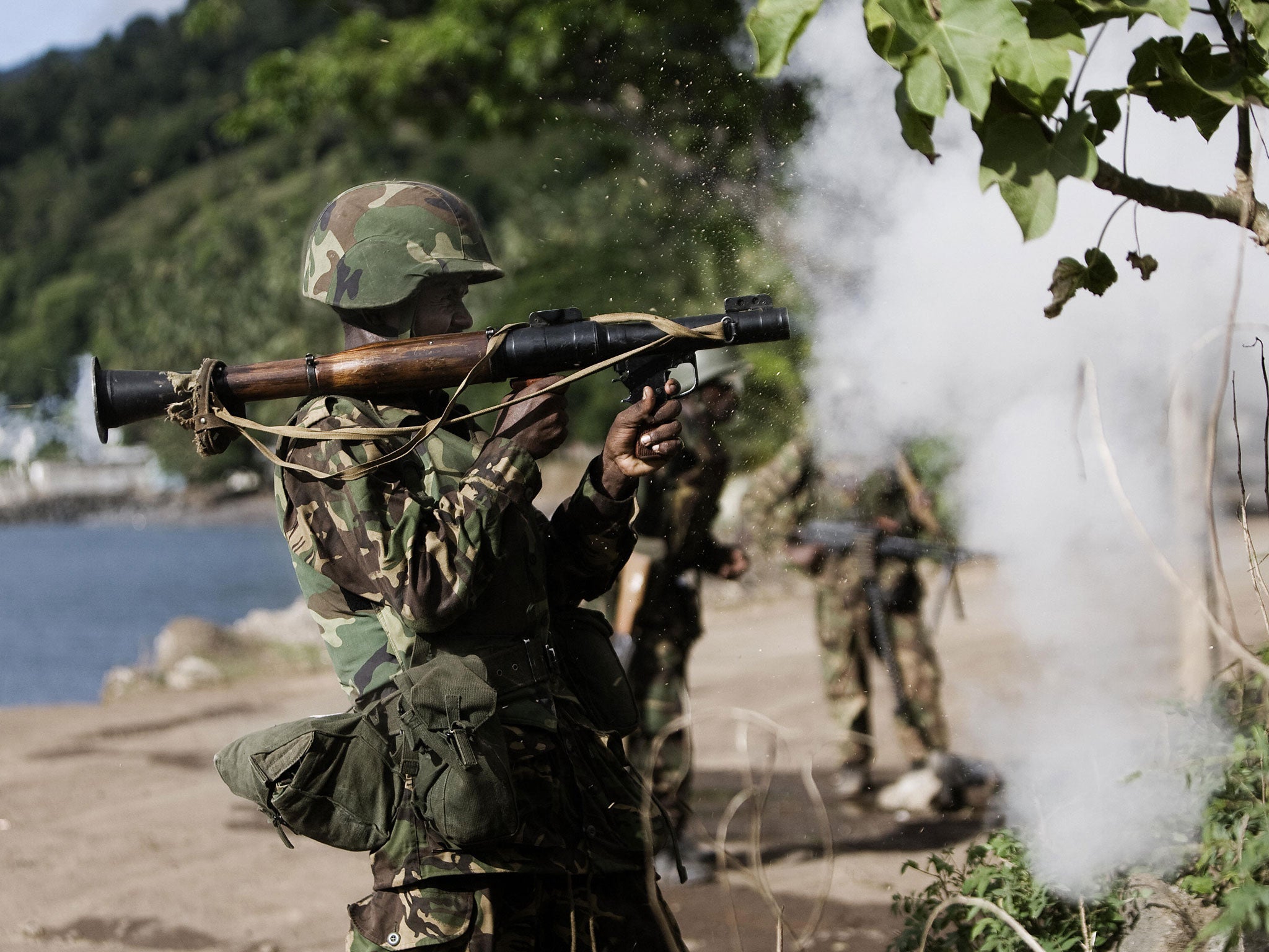 A Tanzanian solider from the African Union fires a rocket