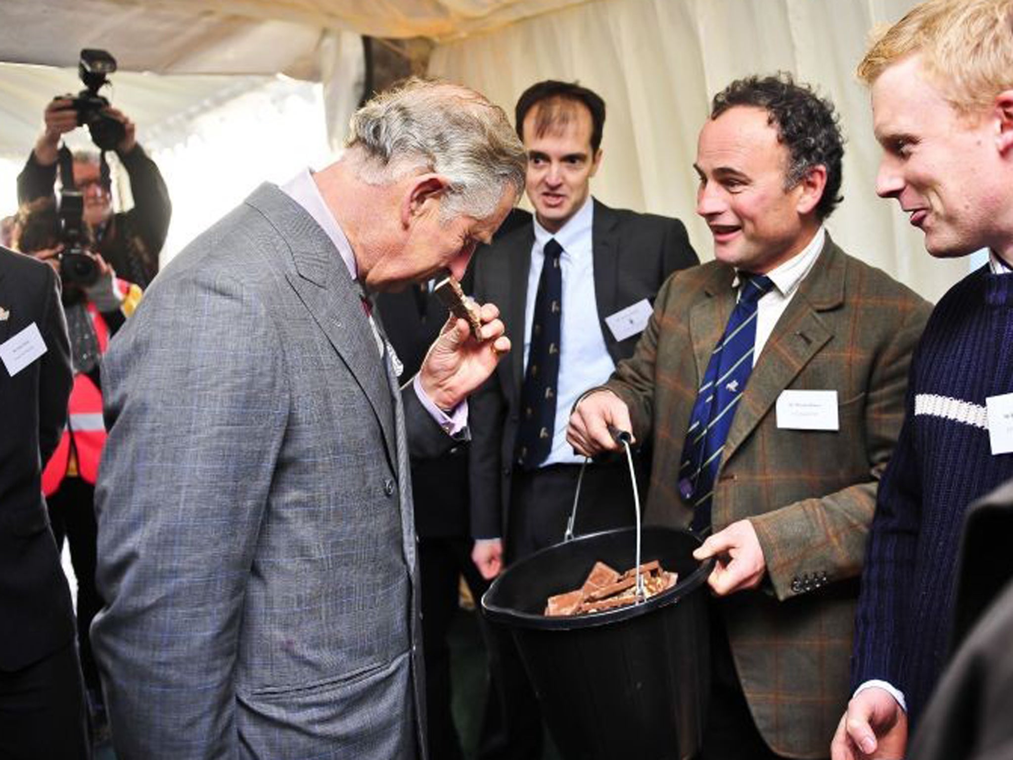 The Prince of Wales smells waste chocolate used in an anaerobic digester during a visit to Dorset this week