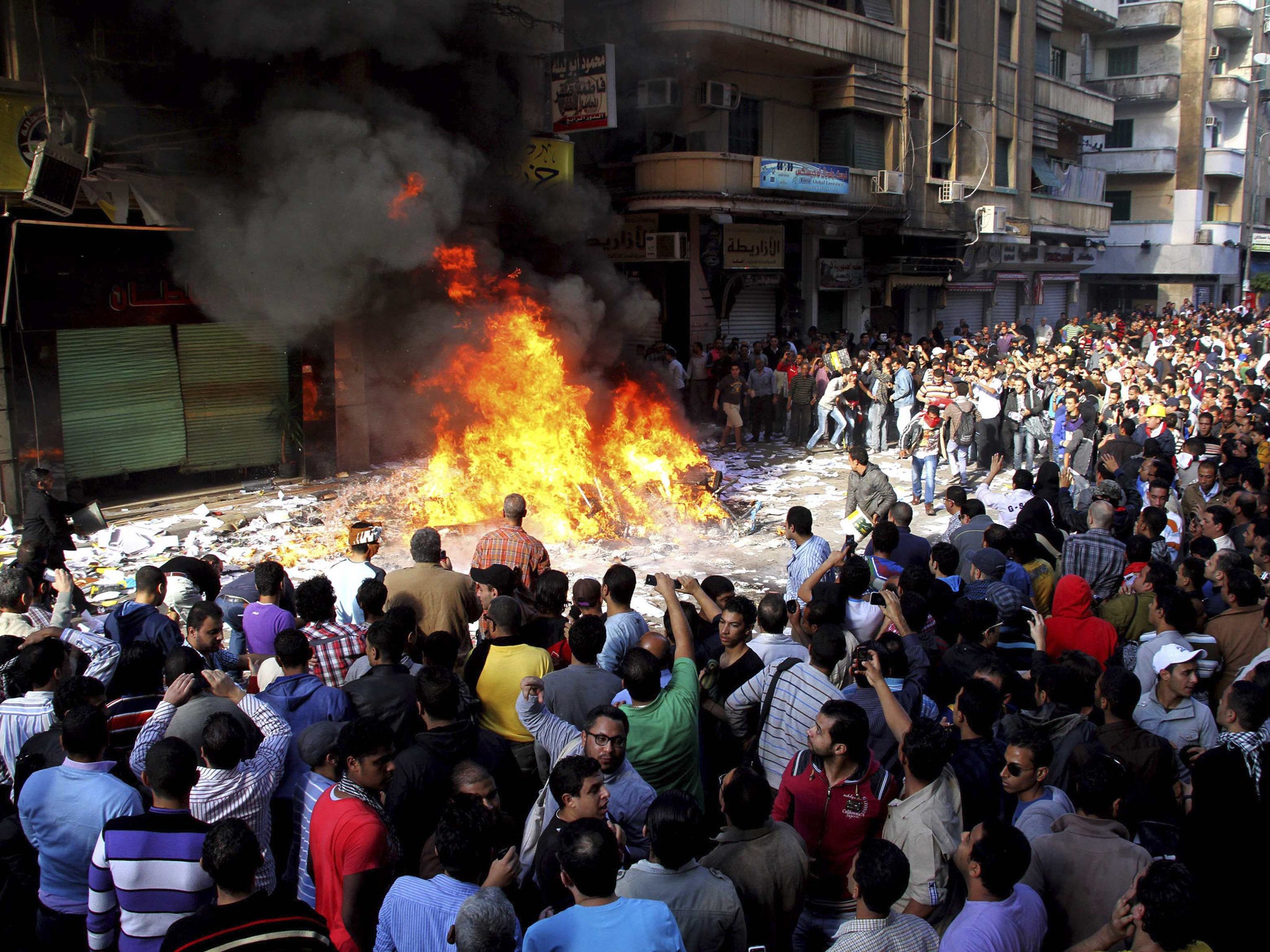 Protesters burn items ransacked from an office of the Muslim Brotherhood’s Freedom and Justice Party in Alexandria yesterday