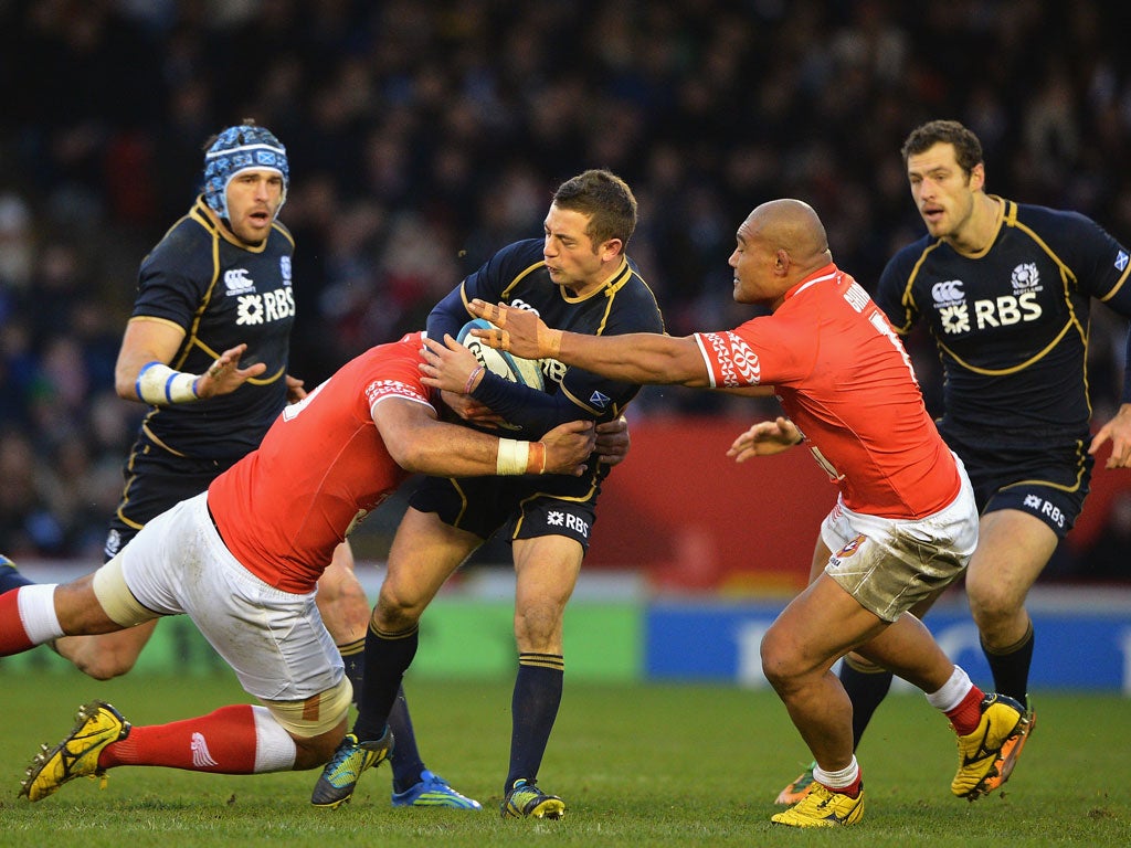 Greig Laidlaw of Scotland is tackled Elvis Taione and Nili Latuof Tonga