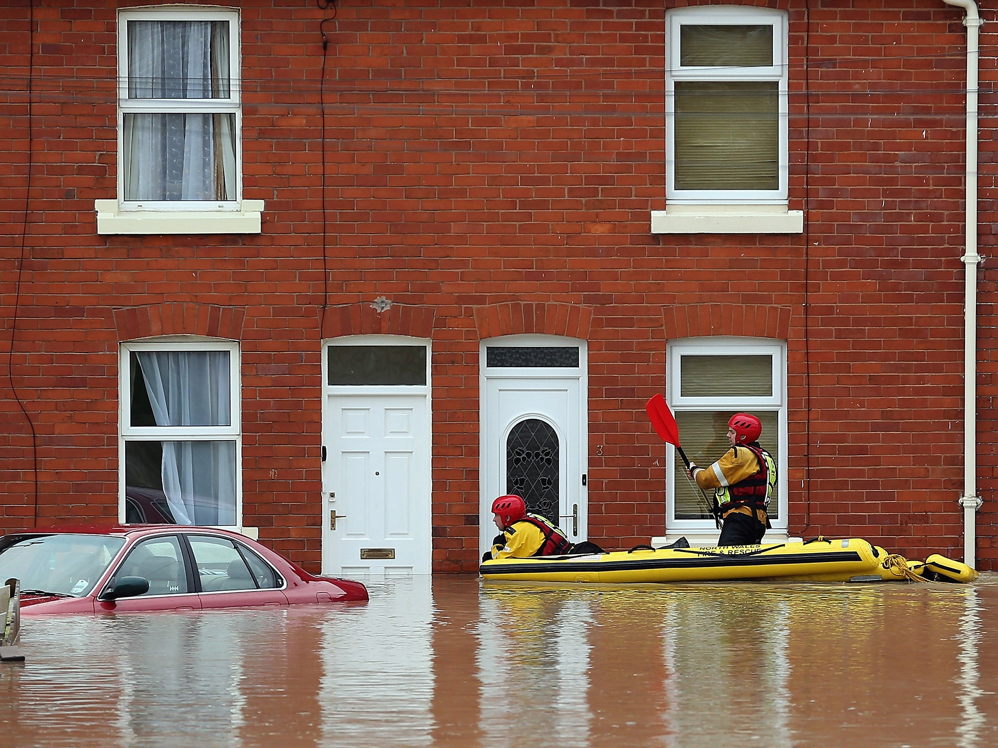 An RNLI life boat crew work in the flooded streets of St Asaph in North Wales
An RNLI life boat crew work in the flooded streets of St Asaph in North Wales