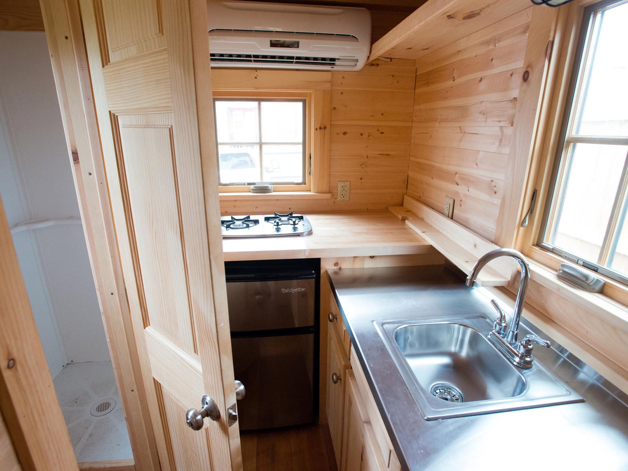TINYHOUSES: The bathroom sits next to the kitchen in this tiny house; despite their diminutive spaces, the houses have fully functioning kitchens and bathrooms.