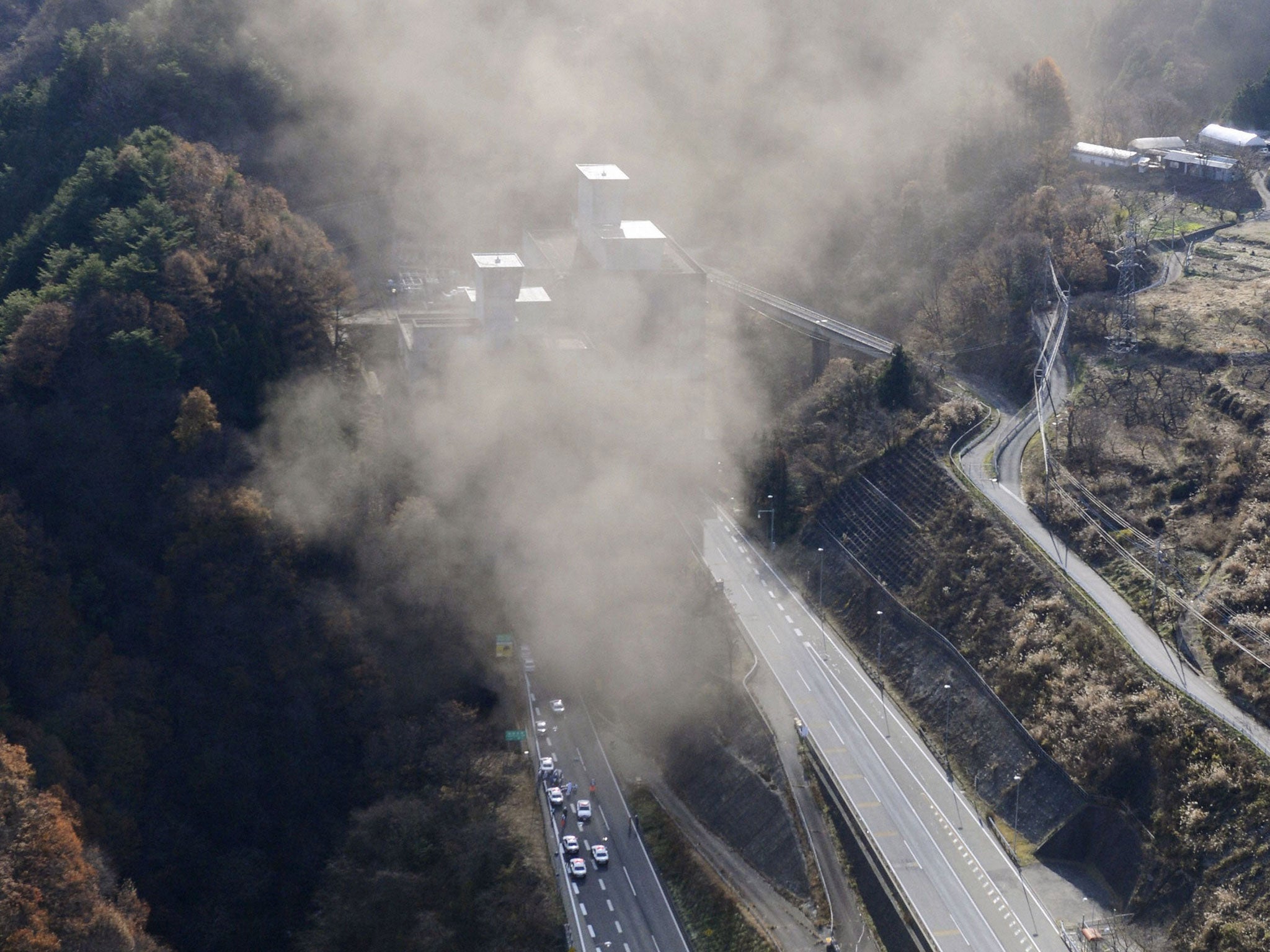 Smoke billows out of the Sasago Tunnel