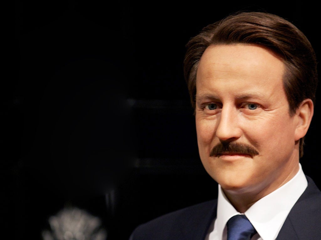 A wax figure of British Prime Minister David Cameron with a moustache is displayed at Madame Tussauds.