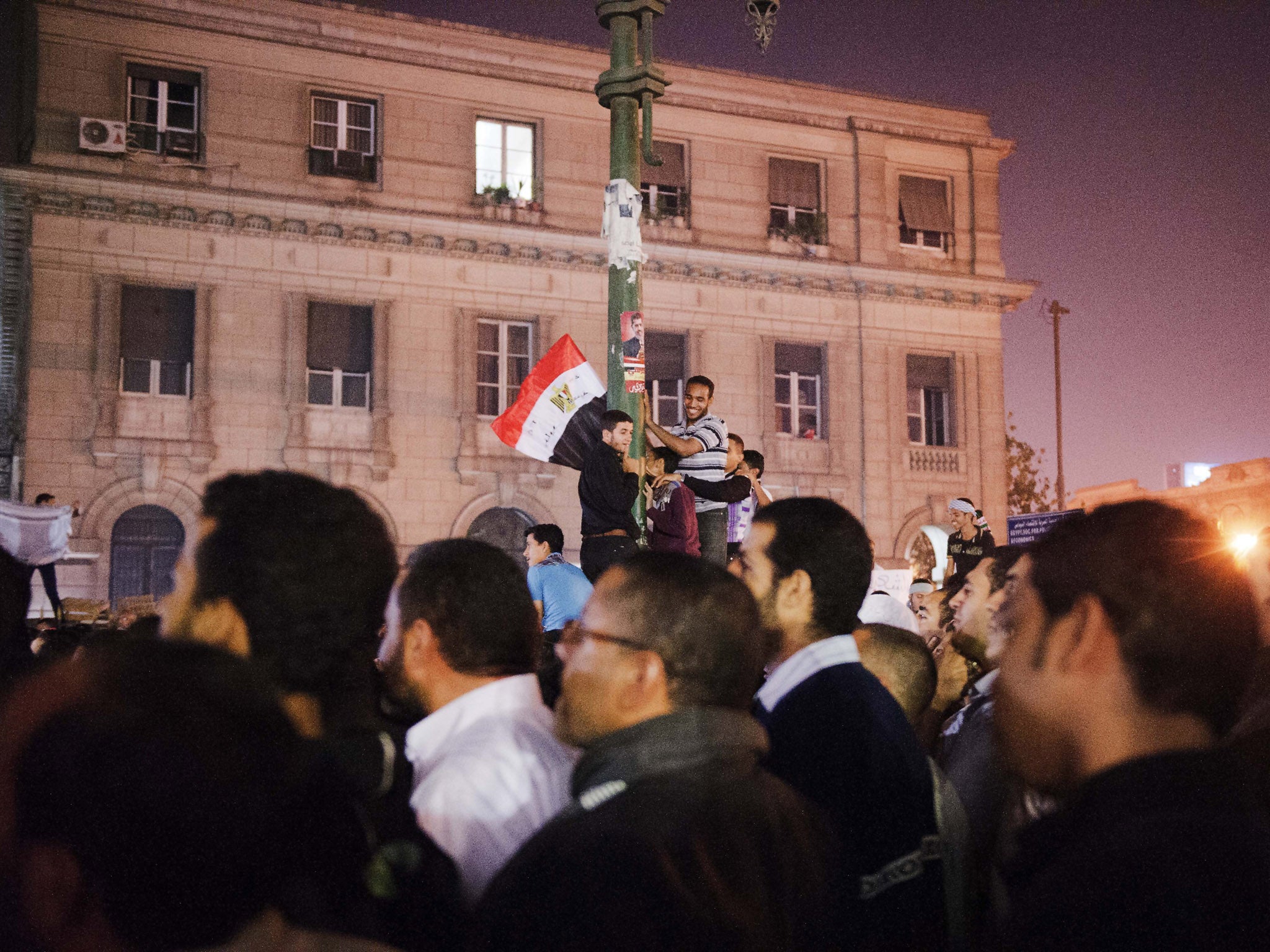 Supporters of Egypt's President Mohamed Morsi wave their national flag as they celebrate in front of the Egyptian high court in Cairo