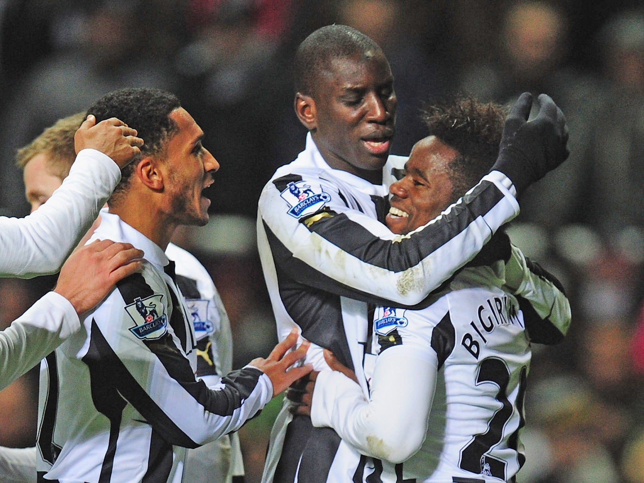 Newcastle scorer Gael Bigirimana (r) is congratulated by Demba Ba after the third goal against Wigan