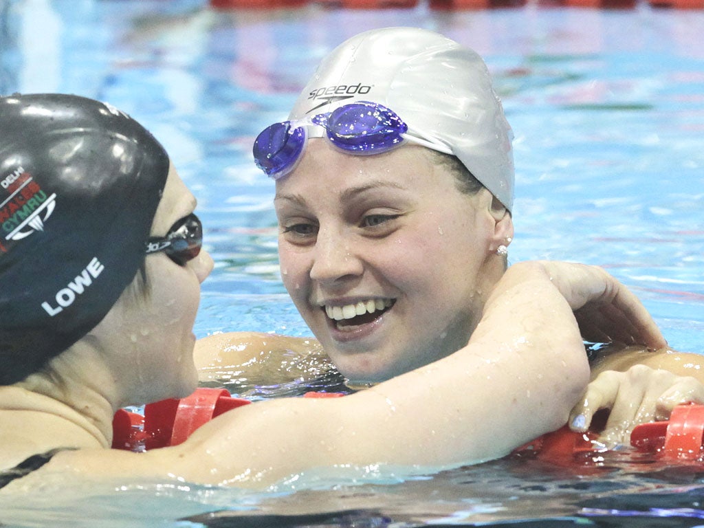 Ellen Gandy after winning gold in the women’s 200m
butterfly is congratulated by Jemma Lowe (left)