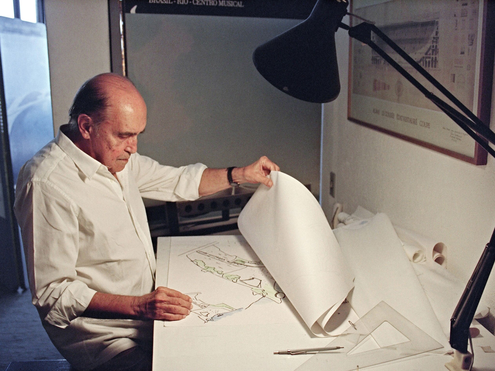 Brazilian architect Oscar Niemeyer looks at drawings for a project of two cities in Senegal, Africa in 1992. He was one of the world's most famous architects, and is particularly beloved in Brazil