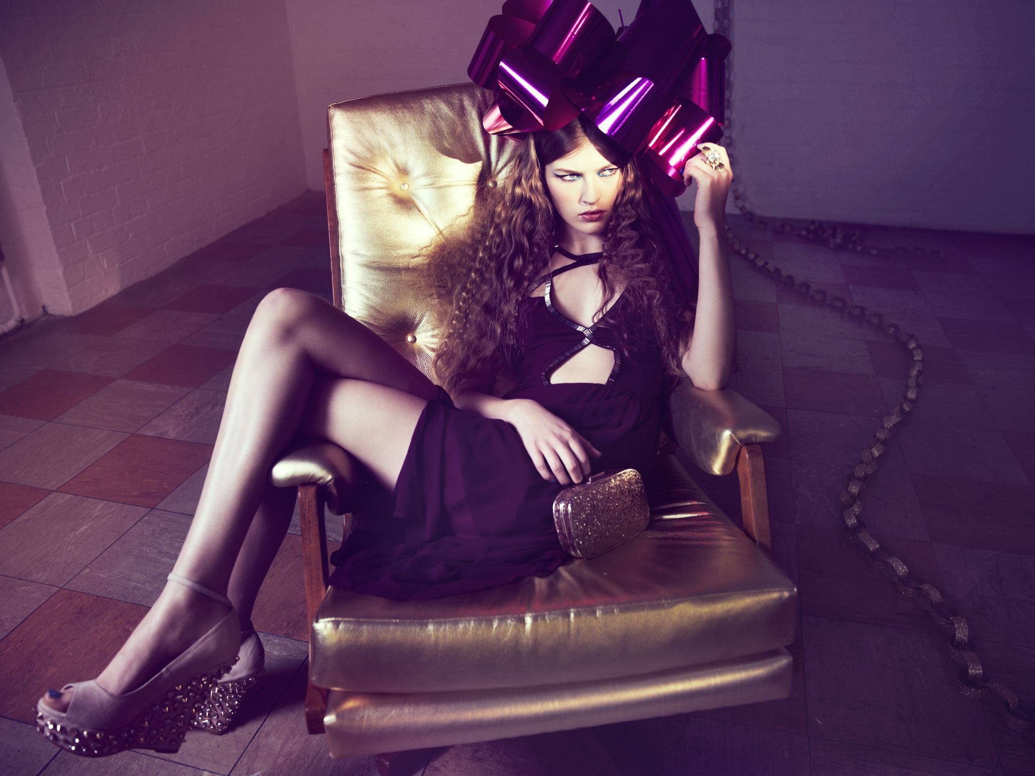 Embellished cutaway dress, £55, by Topshop, topshop.co.uk; studded wedges, £140, by Carvela, kurtgeiger.com; glitter hard-case clutch bag, £30, by Oasis, oasis-stores.com; crystal and gold ring, £125, by Erickson Beamon for The Outnet, theoutnet.com; gold leather armchair, £950, by Pitfield London, pitfieldlondon.com