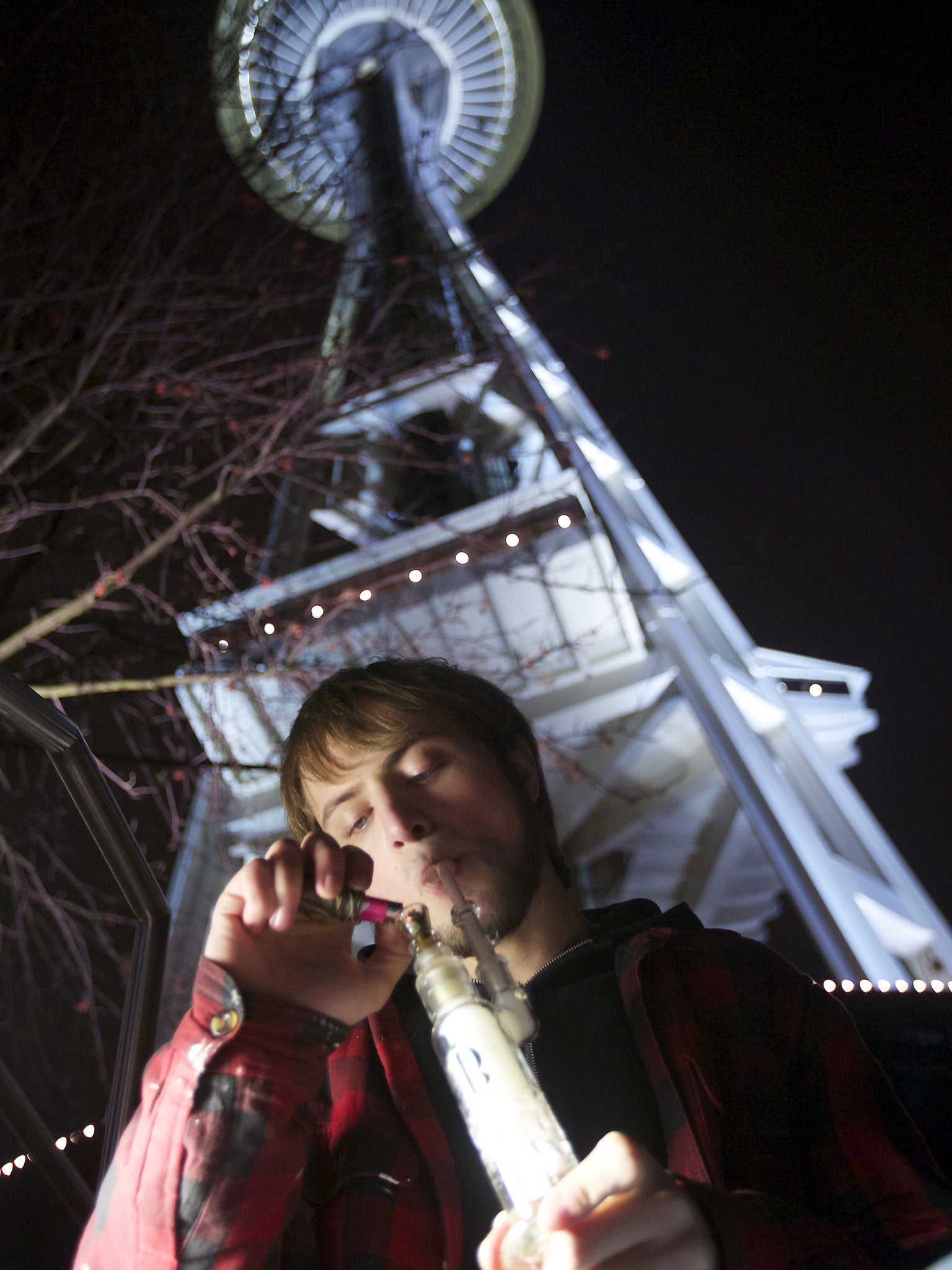 A cannabis smoker marks the start of the new law by the Space Needle in Seattle