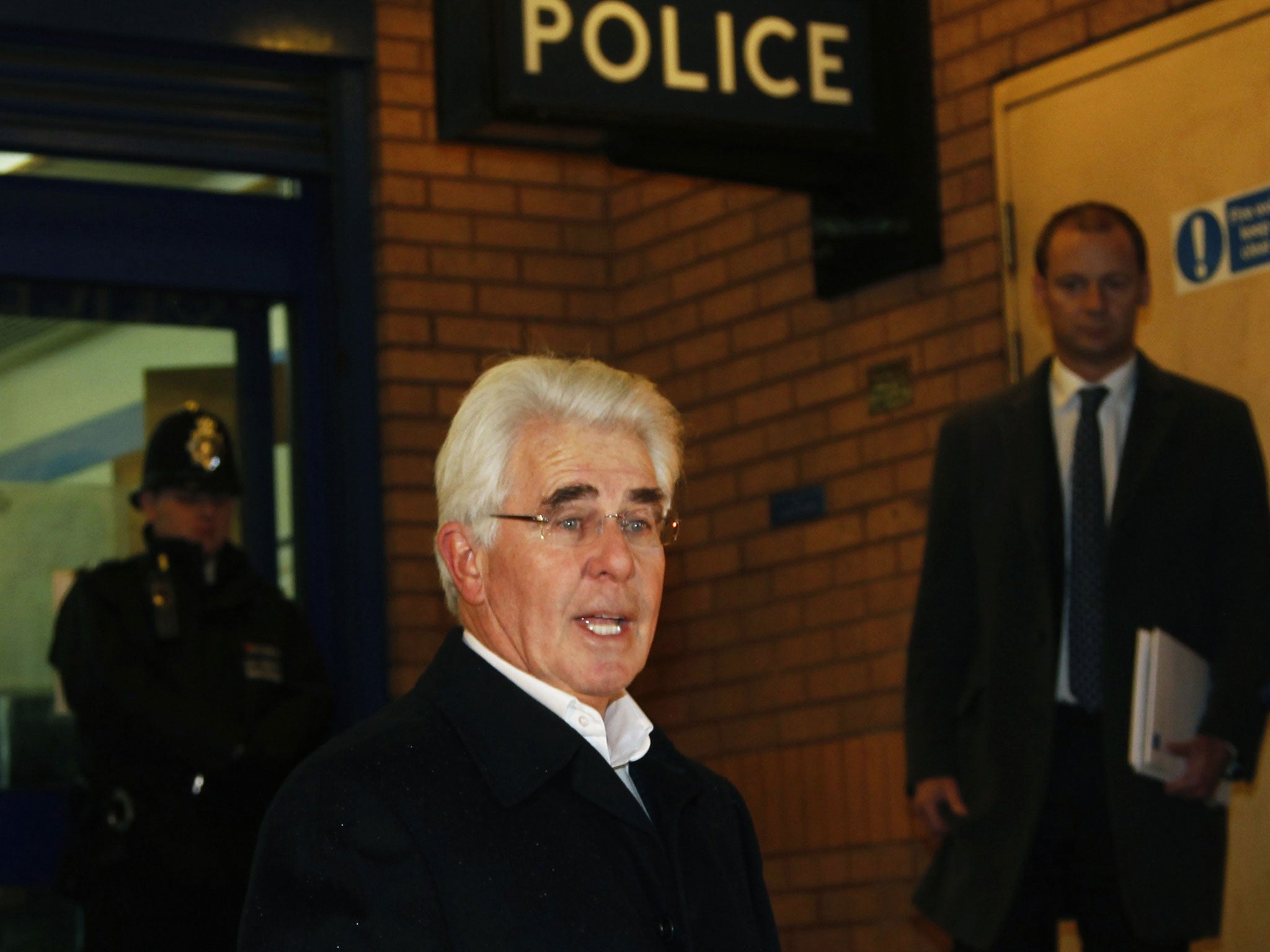 Max Clifford reads a statement after leaving Belgravia police station in London