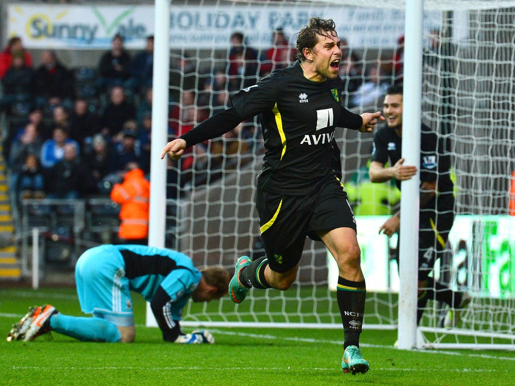 Norwich City's English striker Grant Holt (C) celebrates after scoring their third goal