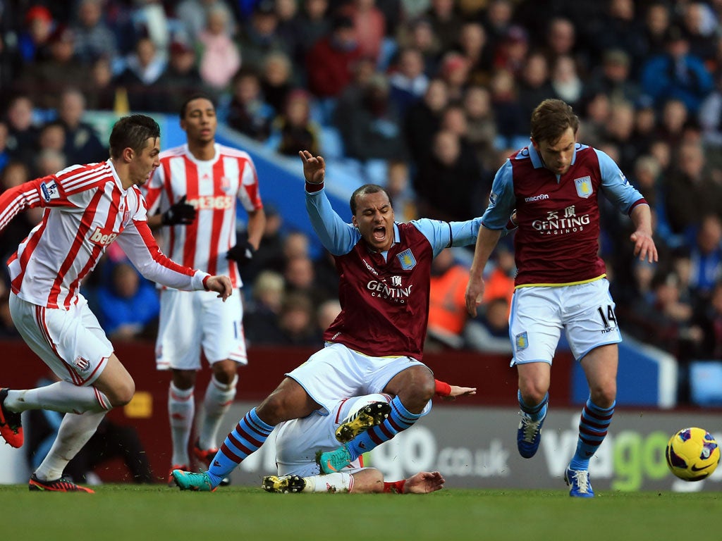 Brett Holman and Gabriel Agbonlahor of Villa goes past Geoff Cameron of Stoke