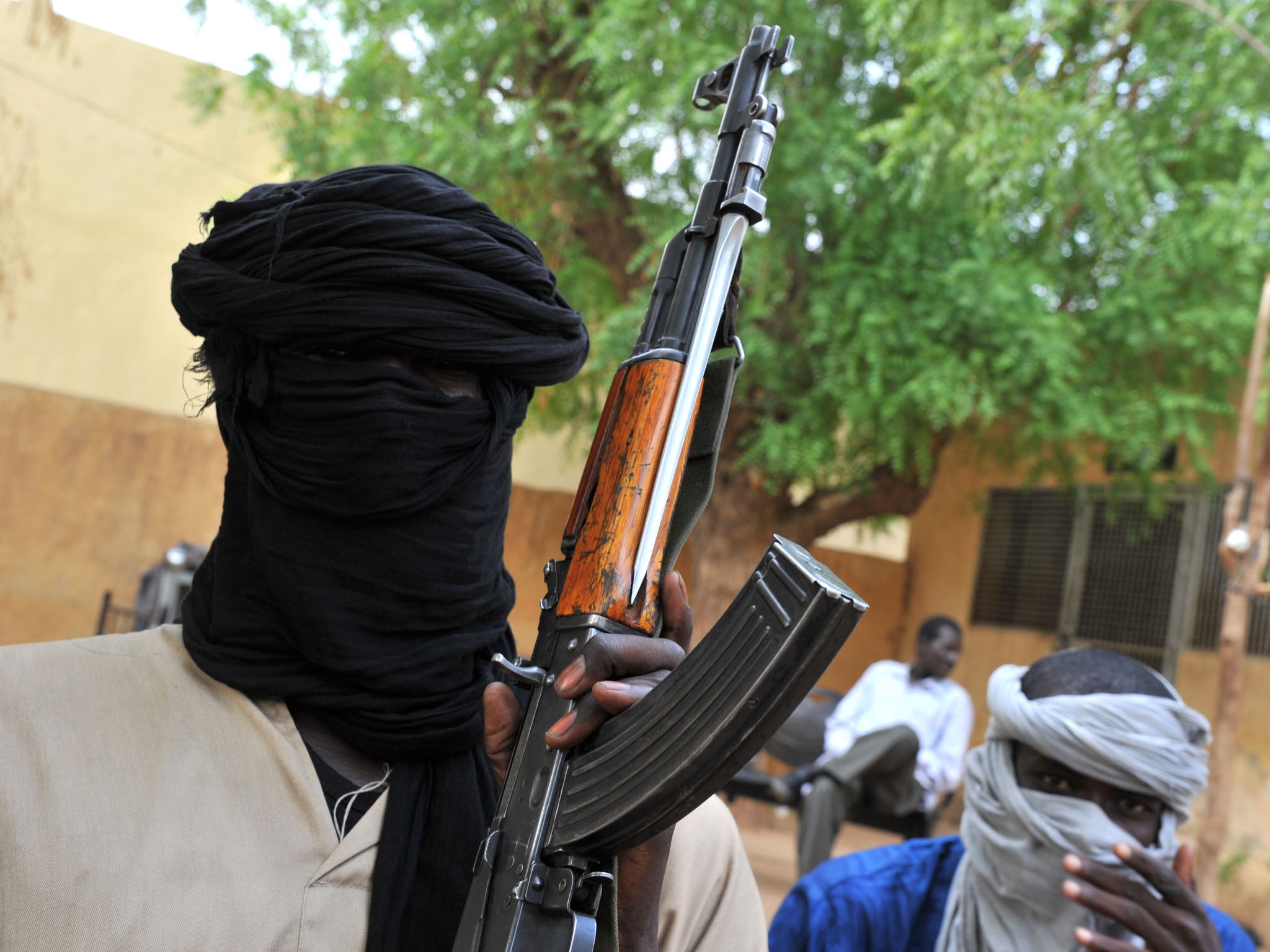 Fighters of the Islamist group Movement for Oneness and Jihad in West Africa (MUJAO) sitting in the courtyard of the Islamist police station in Gao. A group of armed youths has arrived in Gao from Burkina Faso, joining hundreds of other young African recr