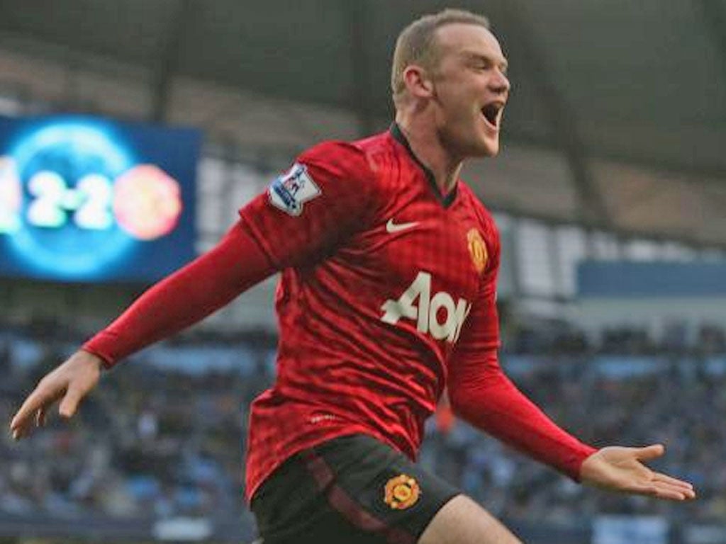 Wayne Rooney of Manchester United celebrates Robin van Persie scoring their third goal