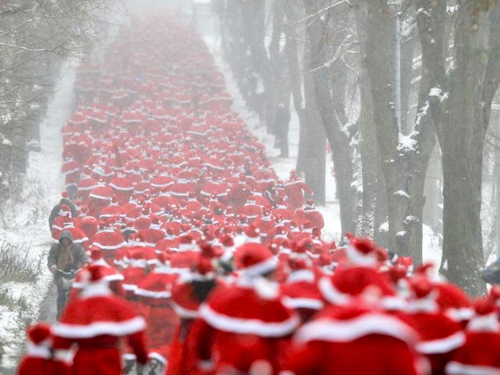 Runners dressed as Father Christmas take part in the so-called 'Nikolaus Run' in the East German town of Michendorf