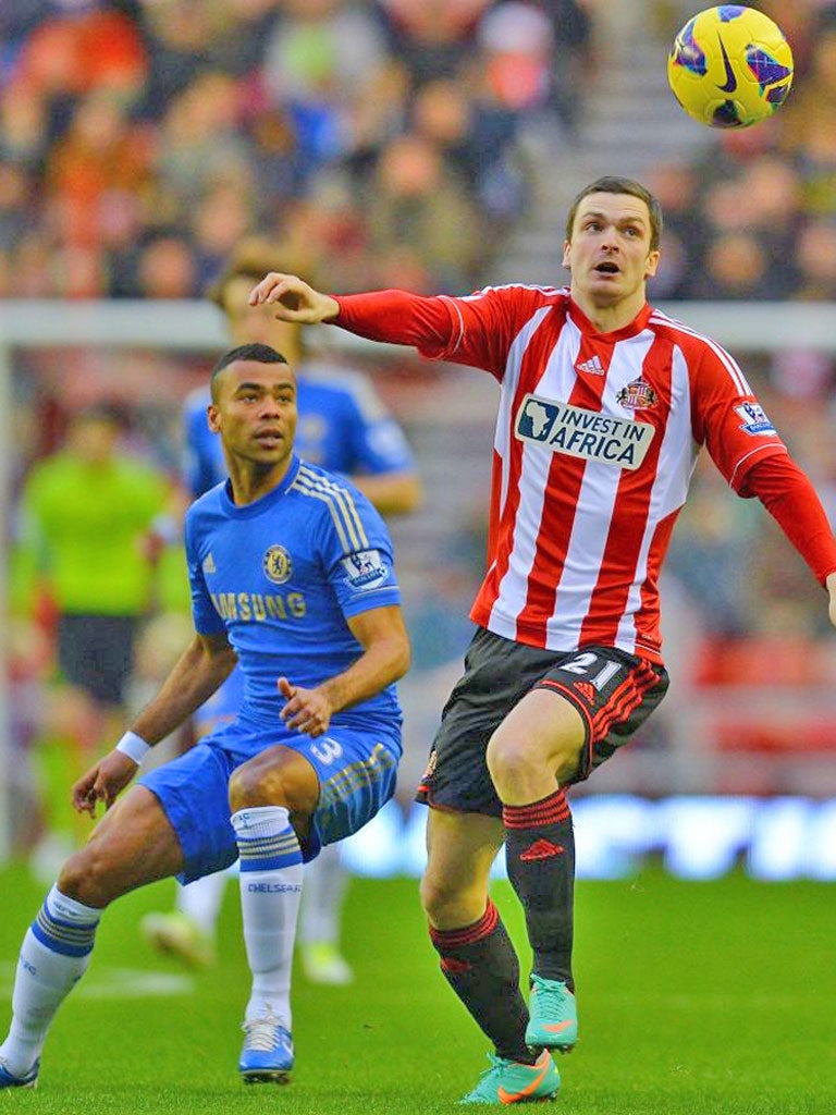 Sunderland’s Adam Johnson (right) tussles with Ashley Cole of Chelsea