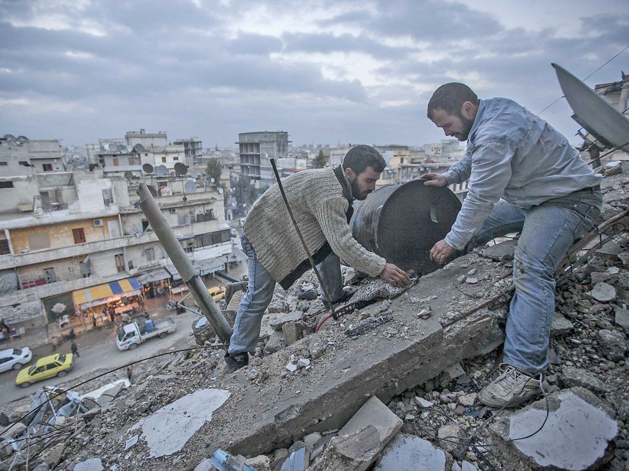 Residents pick through the rubble left after months of heavy fighting in Homs. While mostly calm, periodic explosions still rock the city