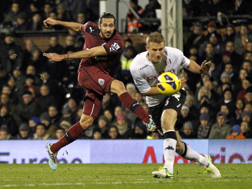 Newcastle United's Jonas Gutierrez has a shot blocked by Fulham defender Brede Hangeland