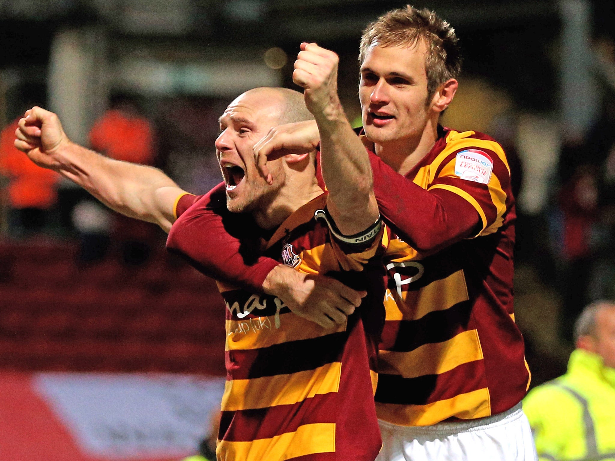 Gary Jones and James Hanson of Bradford celebrate following their victory in the penalty shootout