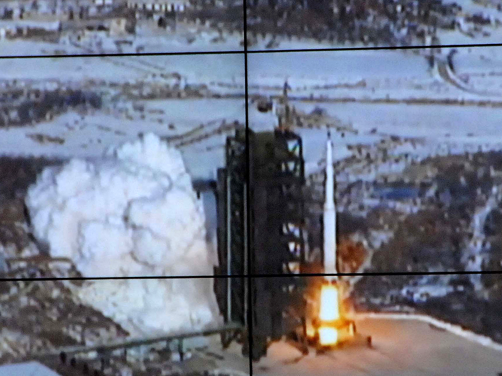 This picture received from North Korea's official Korean Central News Agency on December 12, 2012 shows the rocket Unha-3, carrying the satellite Kwangmyongsong-3, being monitored on a large screen at a satellite control center in Cholsan county, North P