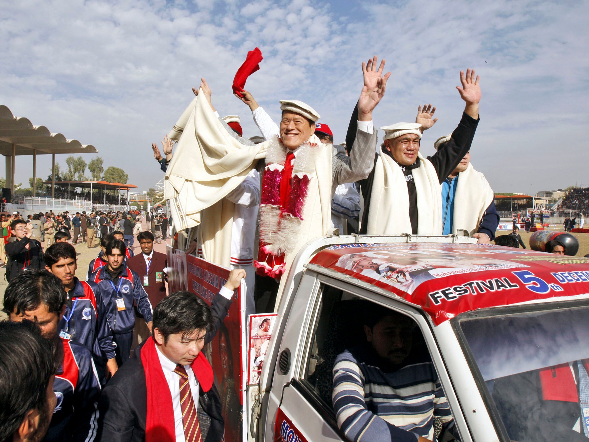 PAKISTAN WRESTLER: Pro wrestling legend Muhammad Hussain Inoki, on left standing in the back of the vehicle, visited Qayyum Stadium in Peshawar, Pakistan. Still known in his native Japan by his performing moniker of Antonio Inoki, he came to Pakistan with