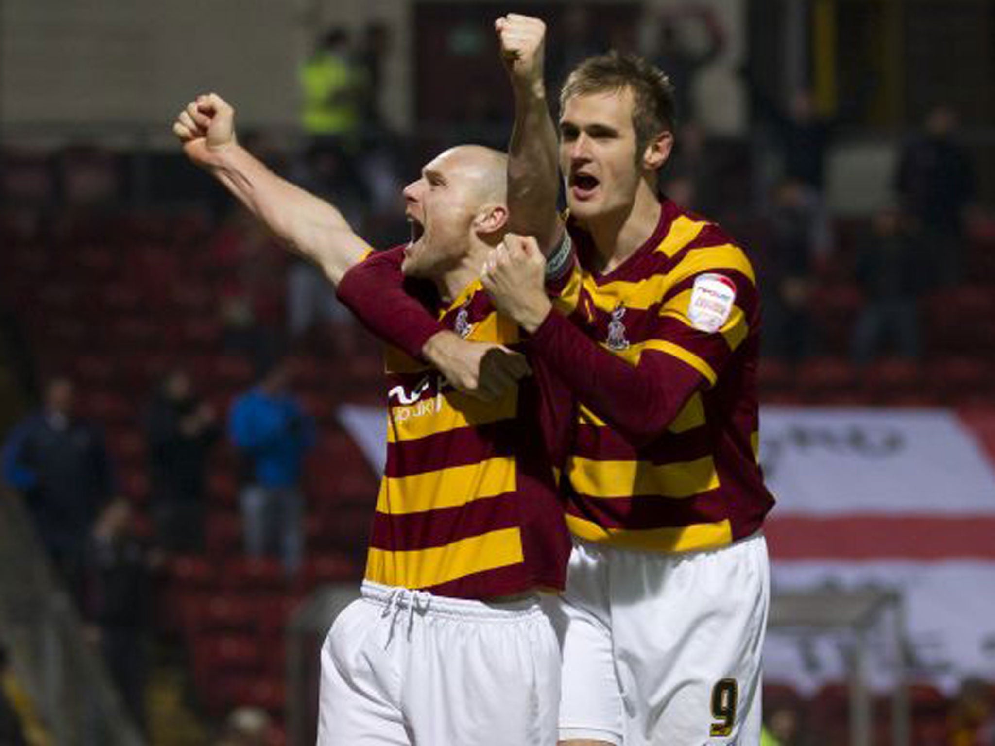 Bradford City’s Gary Jones and James Hanson celebrate beating Arsenal