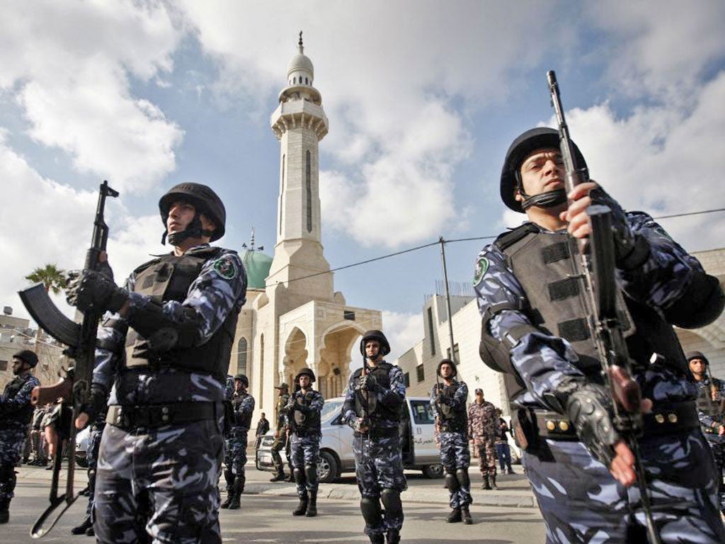 Palestinian security officers march in support of President Mahmoud Abbas yesterday