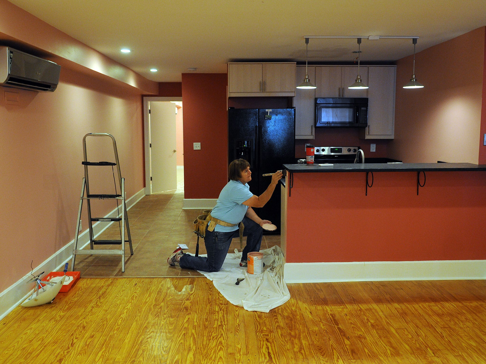 HANDYWOMEN: Cecilia Moore, a contractor, adds finishing touches to a basement apartment in Mount Pleasant that she is renovating. Moore comes from a family that has long worked in home repairs. Until recently, home repair was seen as a male-dominated terr