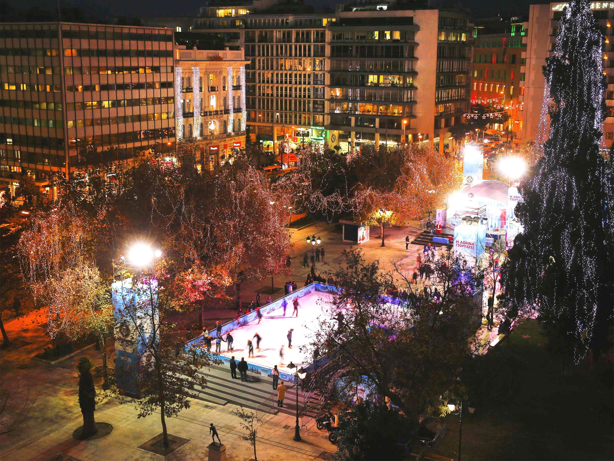 A skating rink and market in Athens yesterday as the pressure eased on Greece