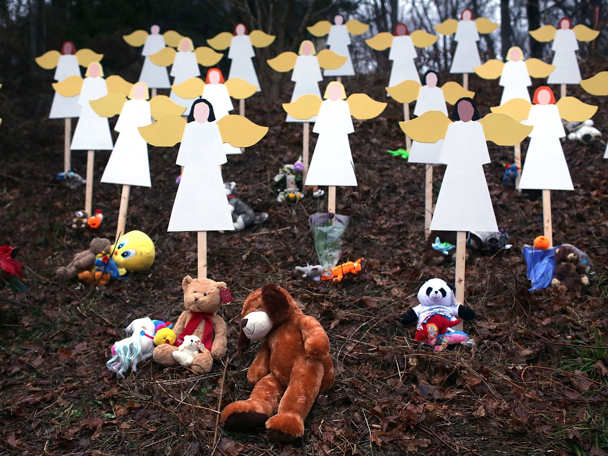 The people of Newtown mourn while police search for a motive for the massacre