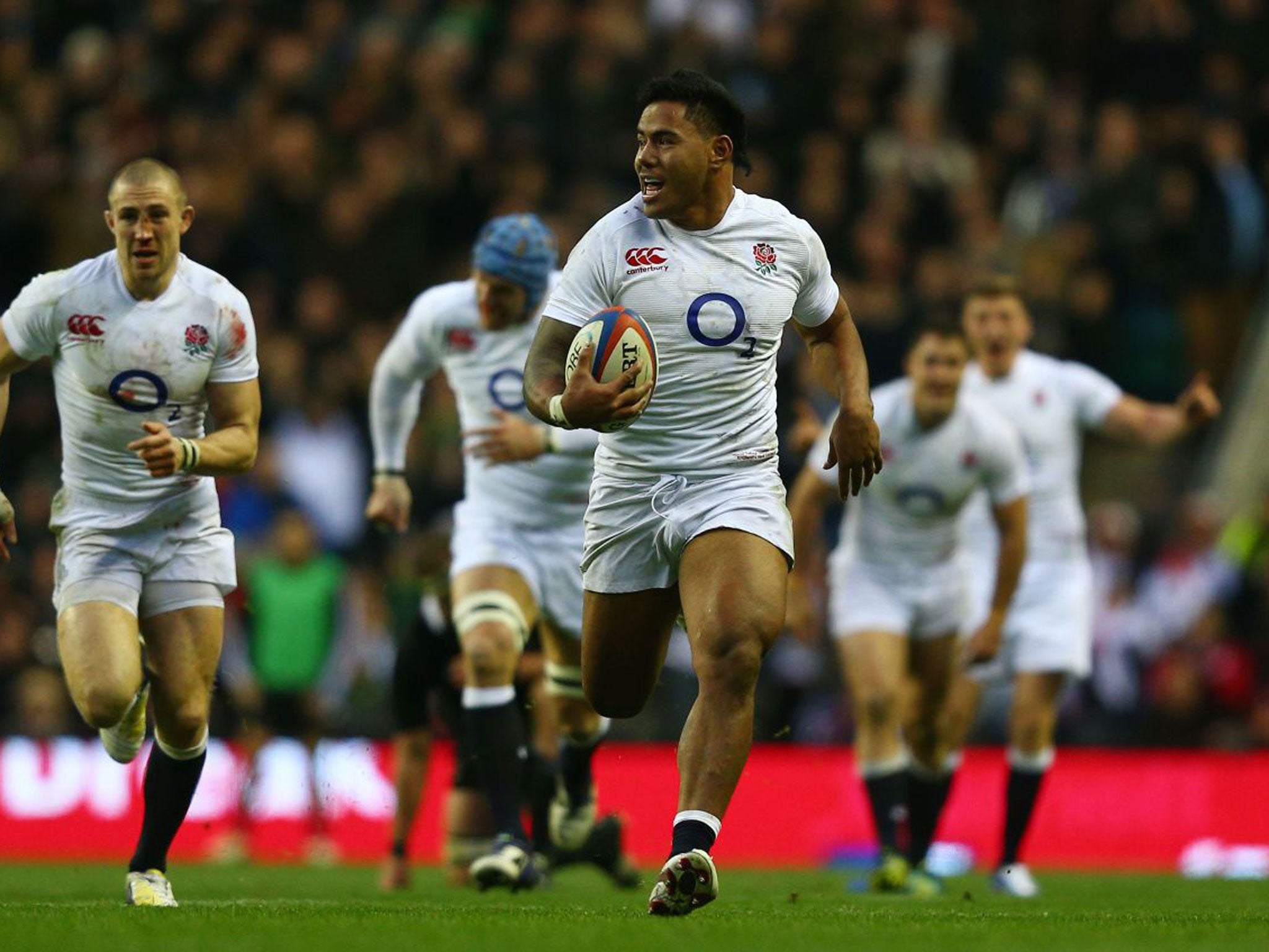 Manu Tuilagi powers towards the line to score against New Zealand