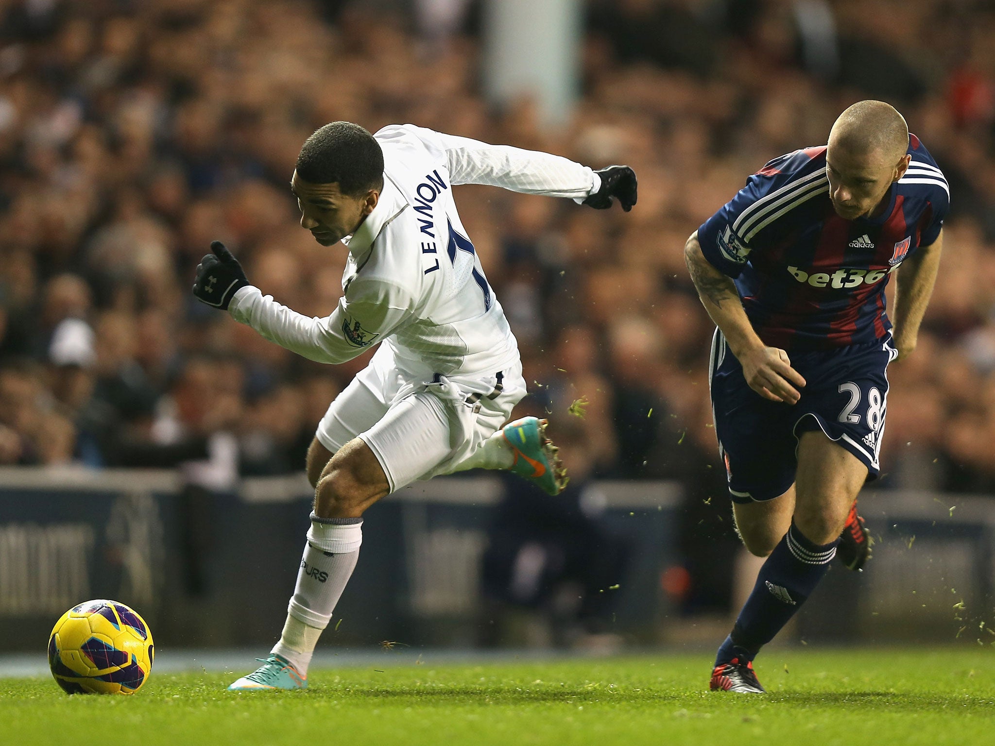 Aaron Lennon of Tottenham Hotspur and Andy Wilkinson of Stoke City tussle for the ball