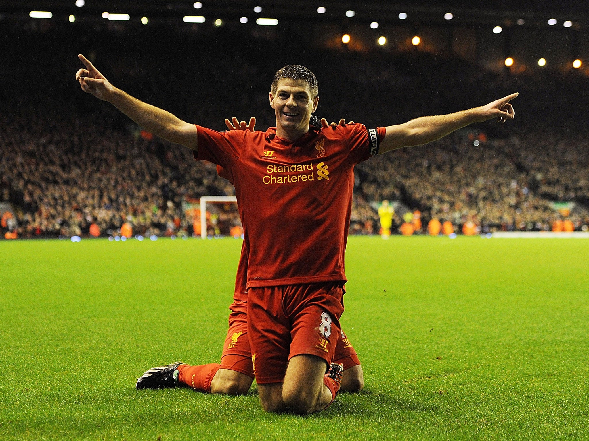 Steven Gerrard (L) of Liverpool celebrates with his team-mate Luis Suarez