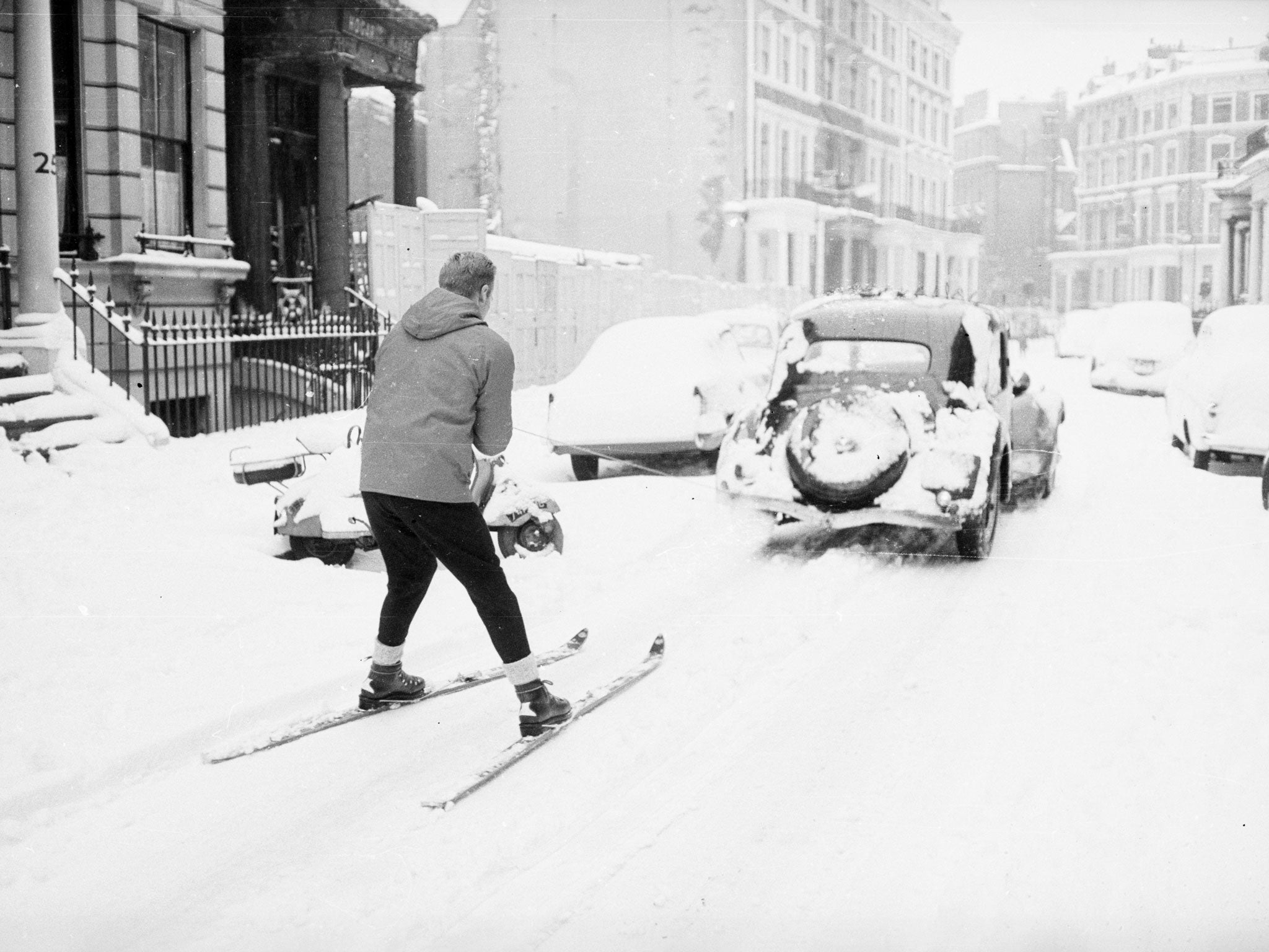 A skier being towed through Earls Court in December 1962