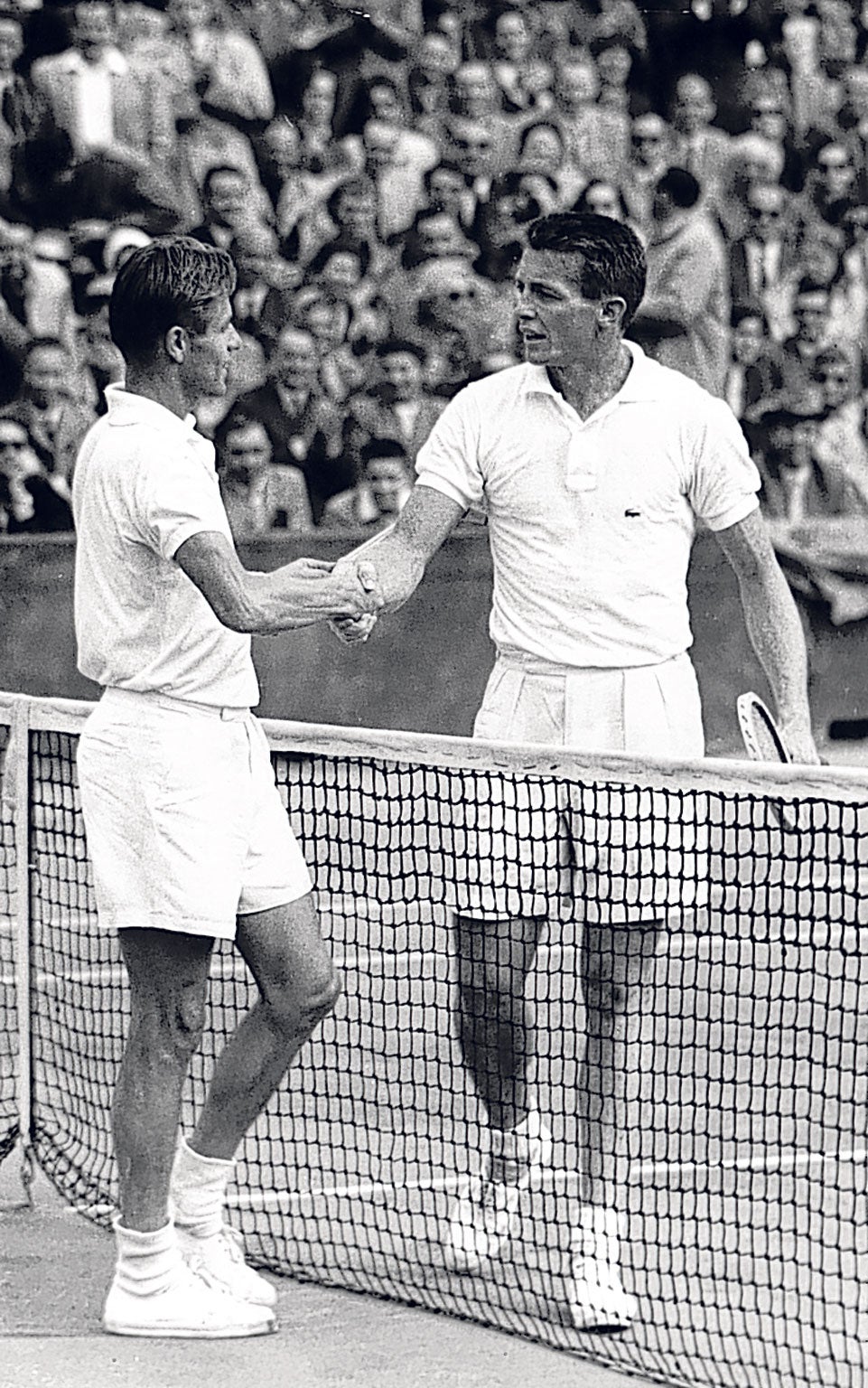 Larsen, right, shakes hands with his fellow-American Tony Trabert after losing to him in the final of the 1954 French Open