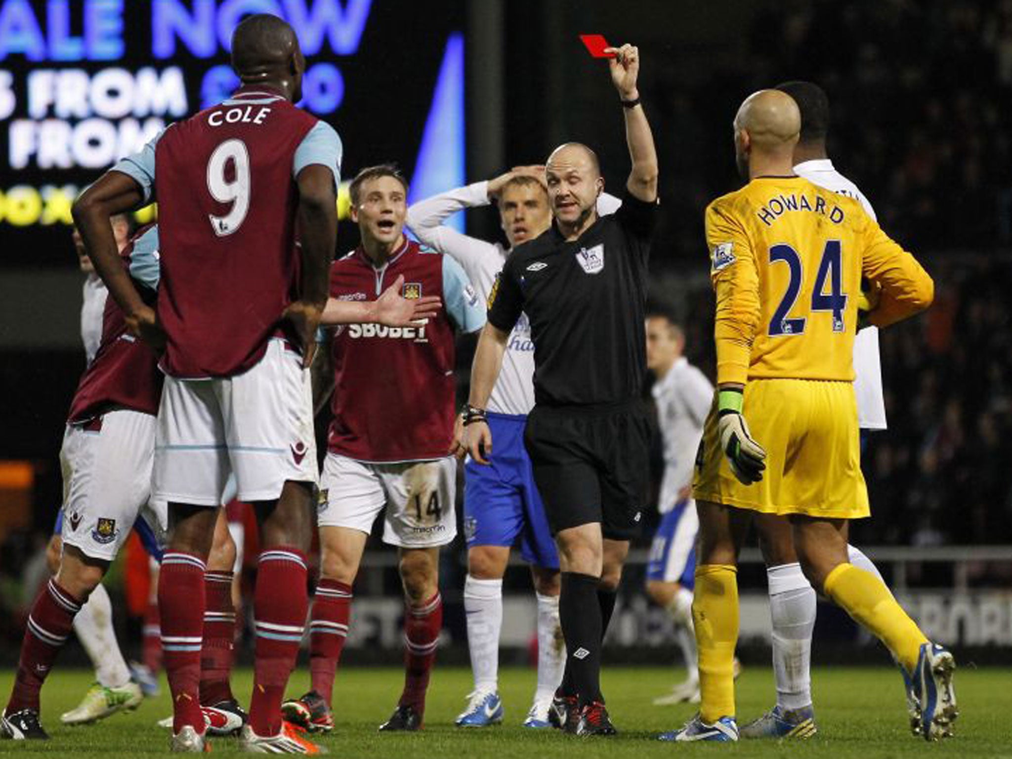 Carlton Cole is shown a red card by referee Anthony Taylor on Saturday