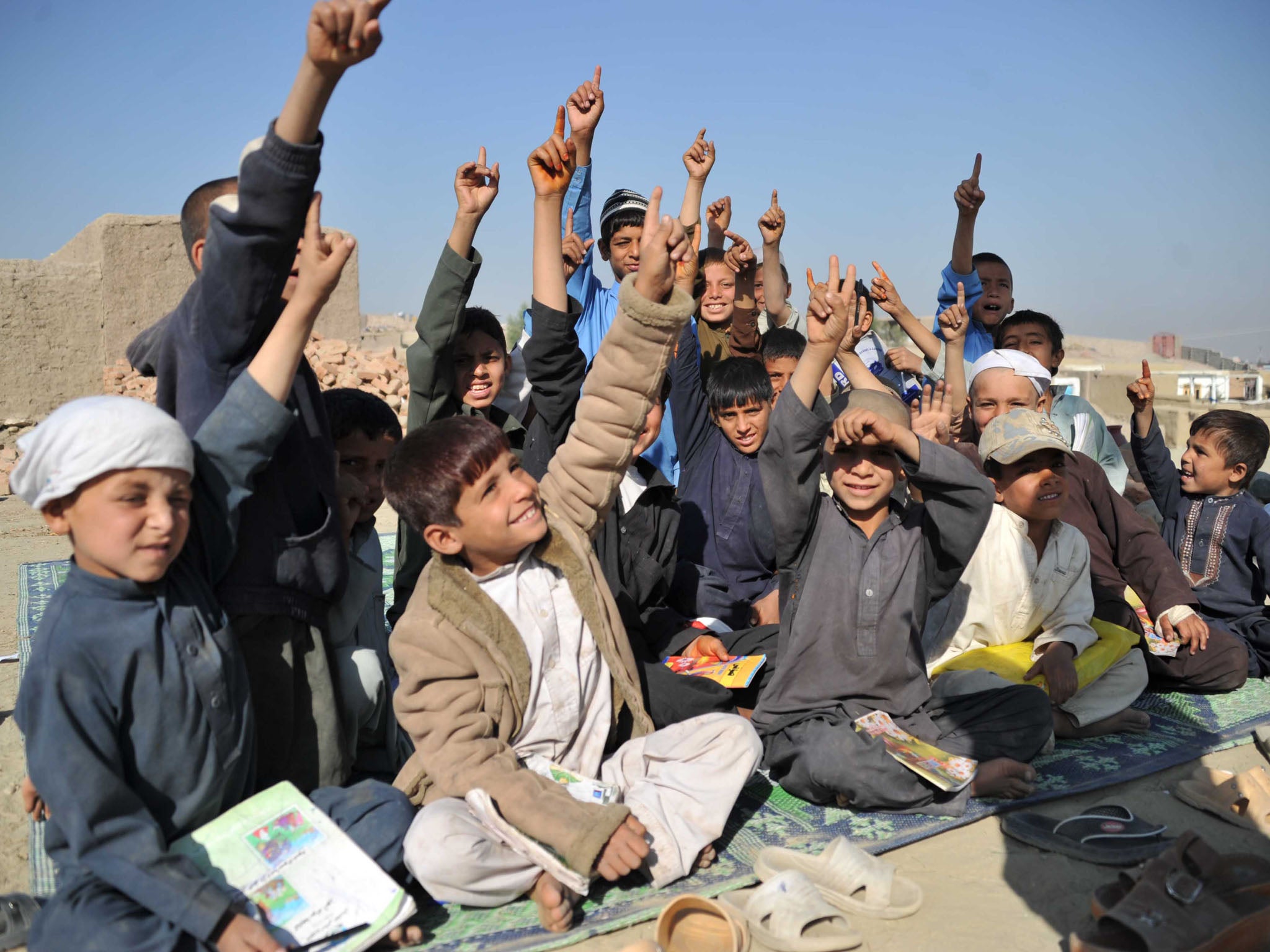 Afghan children attend an outdoor school