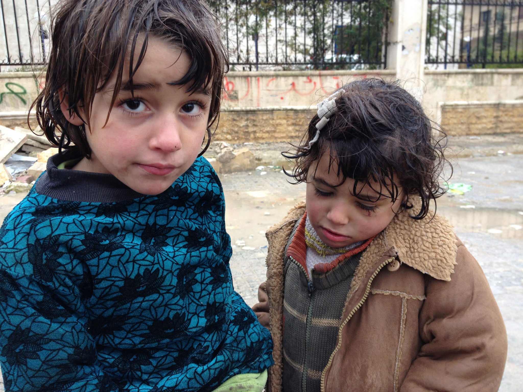 SYRIA: Baraa Labhan, 7, and his sister Fatme, 5, have been reduced to begging with their mother, Nadia, since their father was killed by a sniper two months ago. The price of bread has soared tenfold and many people are going hungry.