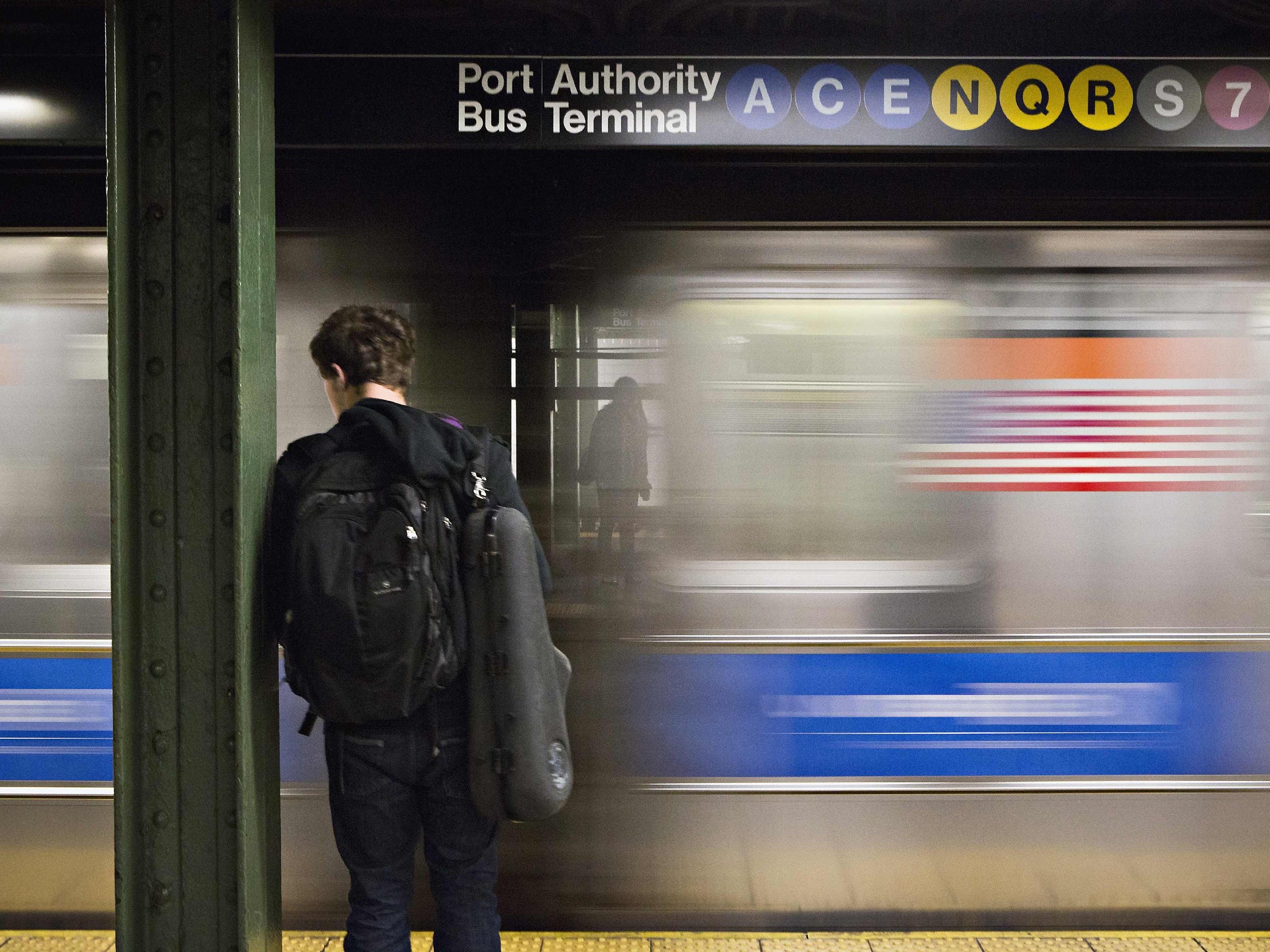 A man waits for the subway at the Times Square stop in New York