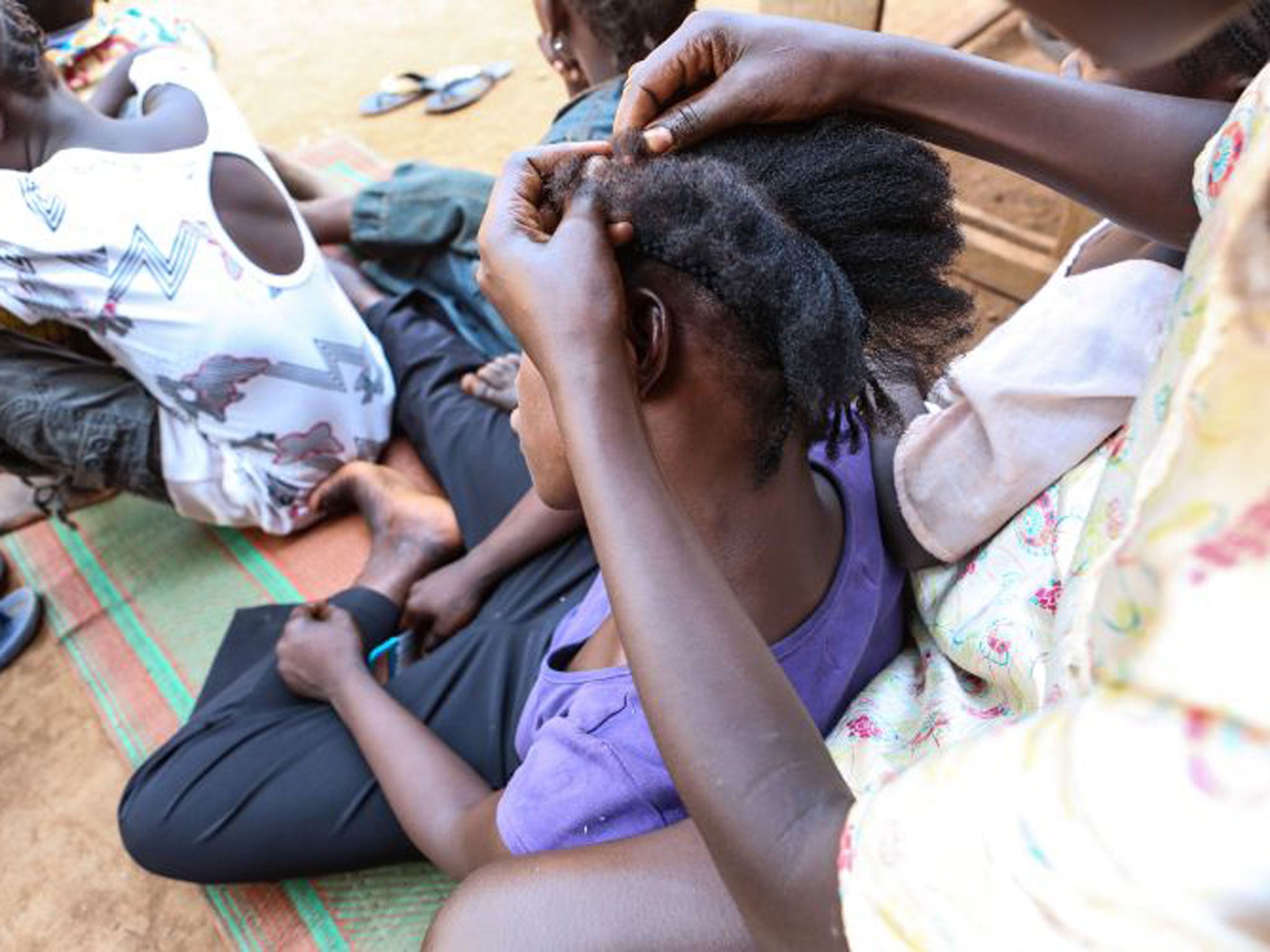 Clemence, 16, has her hair done after being reunited with her mother