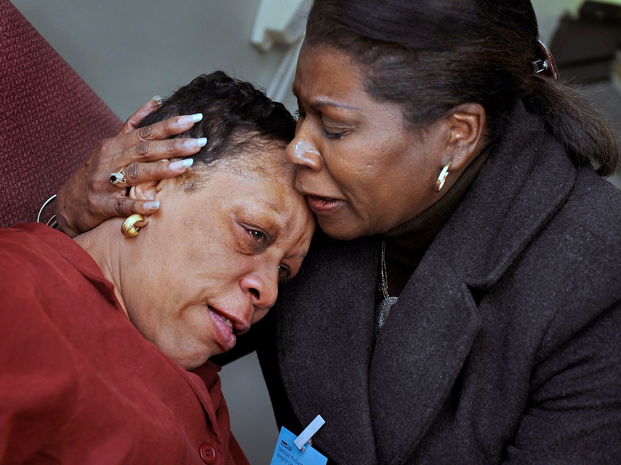 Pat Hawkins, left, is emotional after reuniting with her cousin, Diane Holmes, of Richmond, California, who had just flown to Washington from California. The reunion took place at MedStar Washington Hospital Center, where Hawkins, who had suffered mini-st