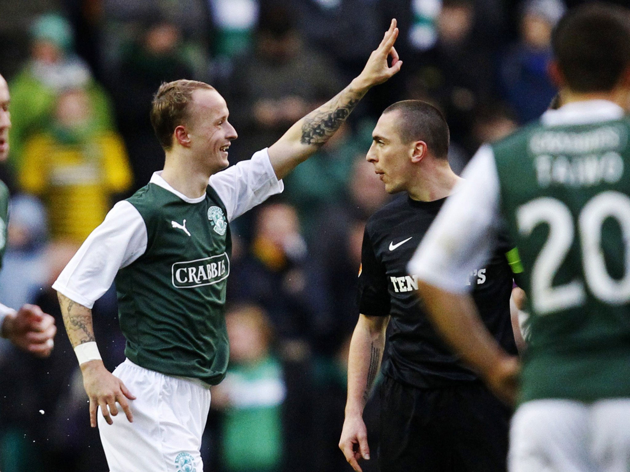 Green for go: Hibs’ Leigh Griffiths celebrates his winner against Celtic