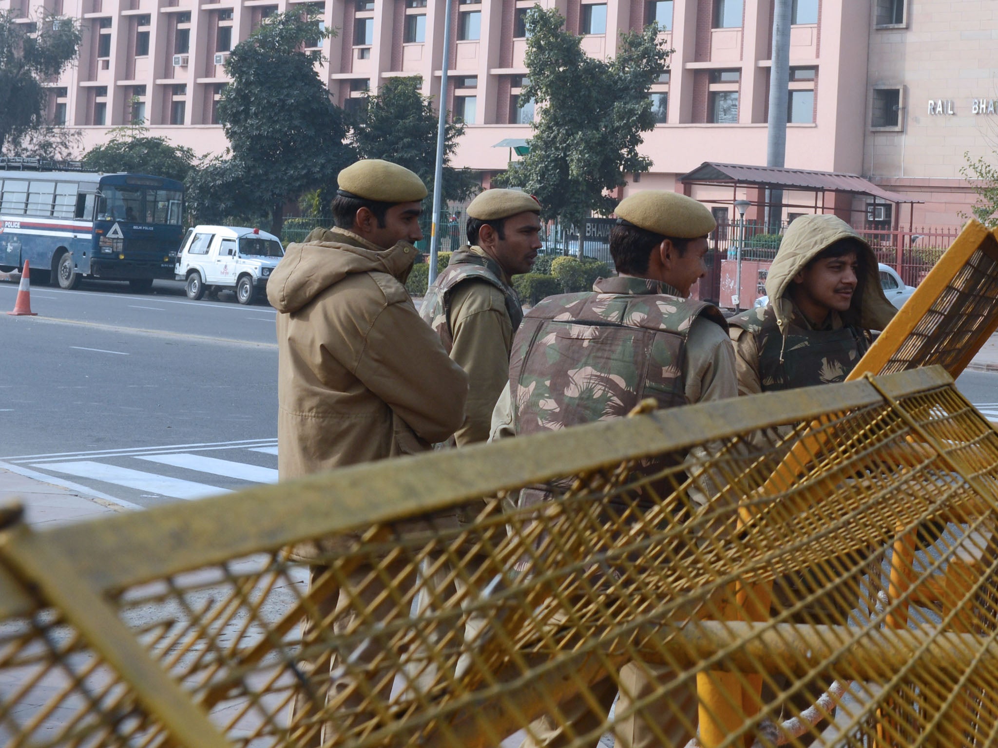 Indian police personnel stand guard at barrier across a closed road in New Delhi after the cremation ceremony for a gangrape victim. The victim of a gang-rape and murder which triggered an outpouring of grief and anger across India was cremated at a priva