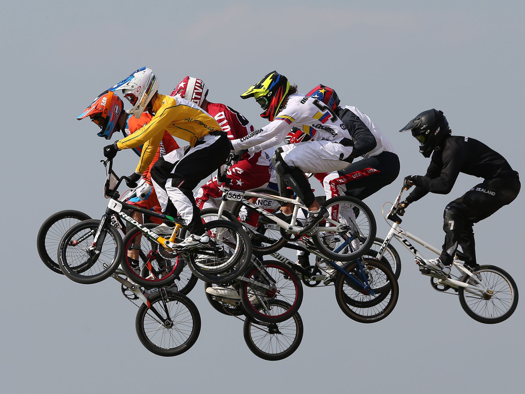 BMX bikers take to the air during the men’s event at the London Olympics