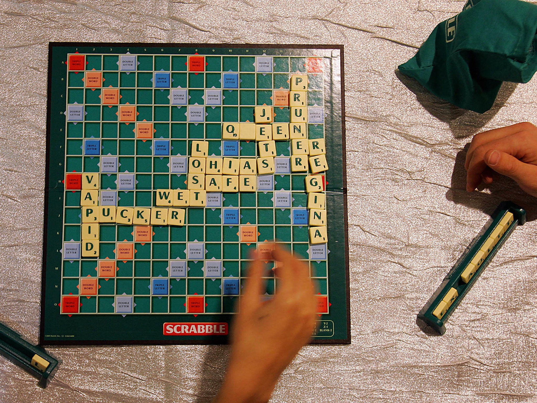 World Champion Scrabble player Panupol Sujjayakorn (L) plays John Lawrence from Texas, US, in the Hamleys toy store in London, 15 November, 2005.